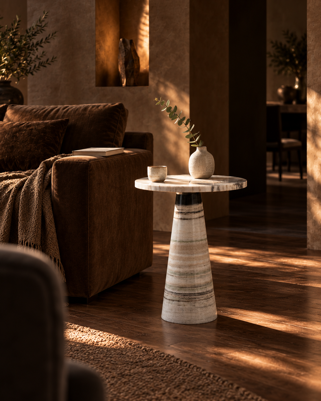 Vellora marble side table beside seating in a shadowed living room