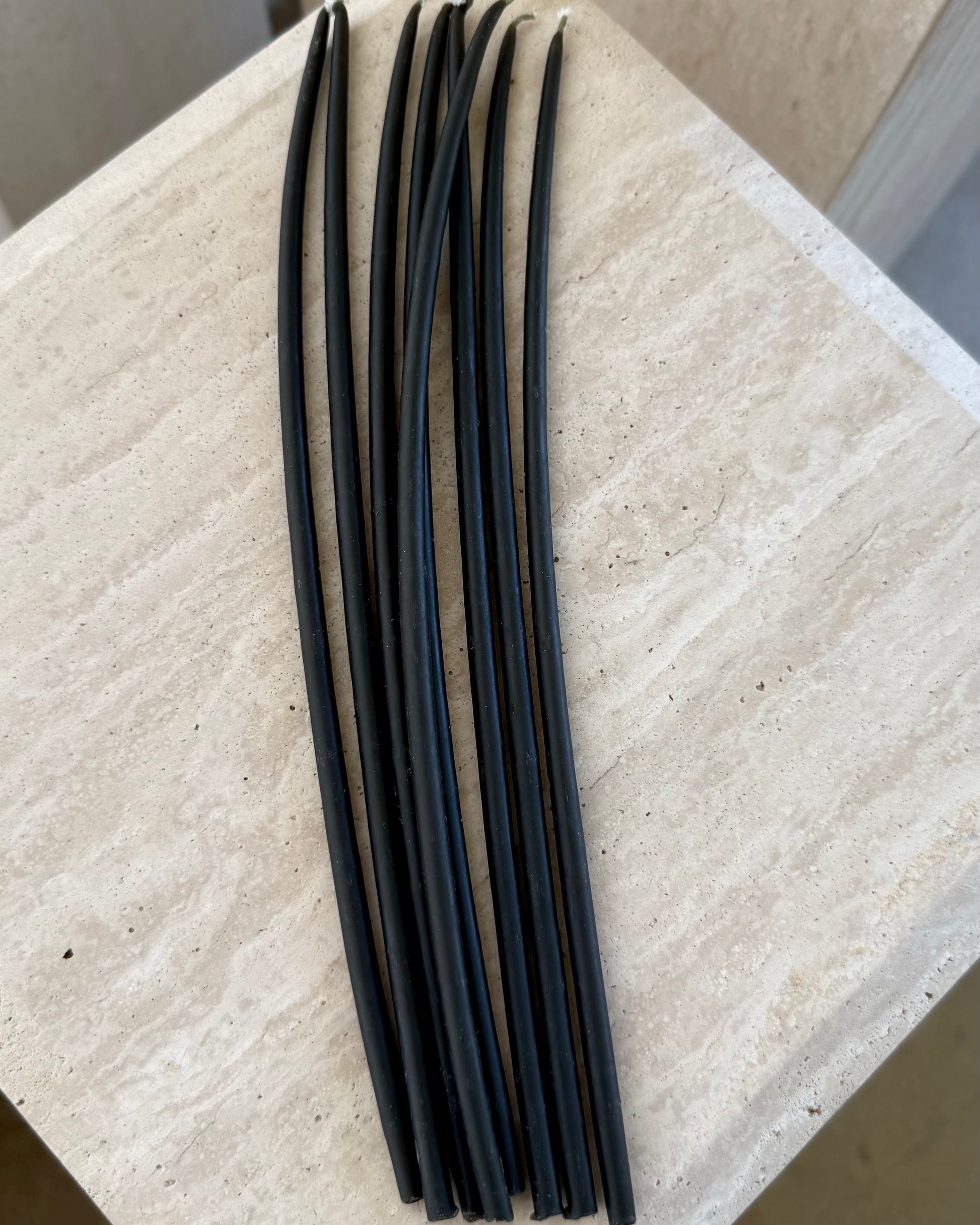 Set of 10 black beeswax taper candles by Belaré Home, elegant and eco-friendly for home decor.