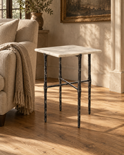 Avelis Marble Accent Table beside a linen armchair in a sunlit sitting room.
