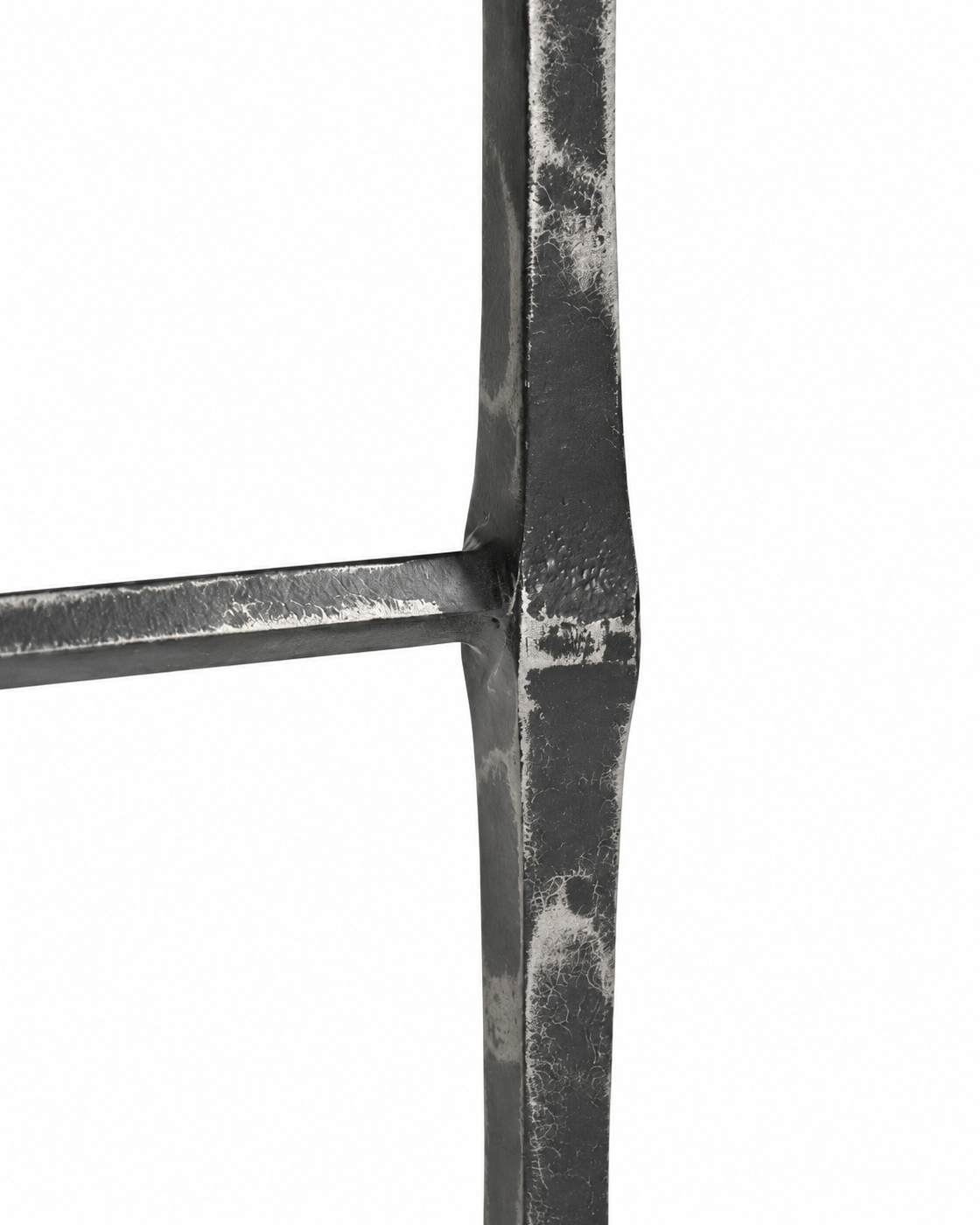 Close view of the Avelis Marble Accent Table hammered metal leg and brace connection.