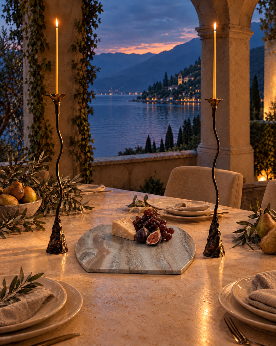 Thanksgiving table with a marble charcuterie board and Ferra Rose taper holders at dusk