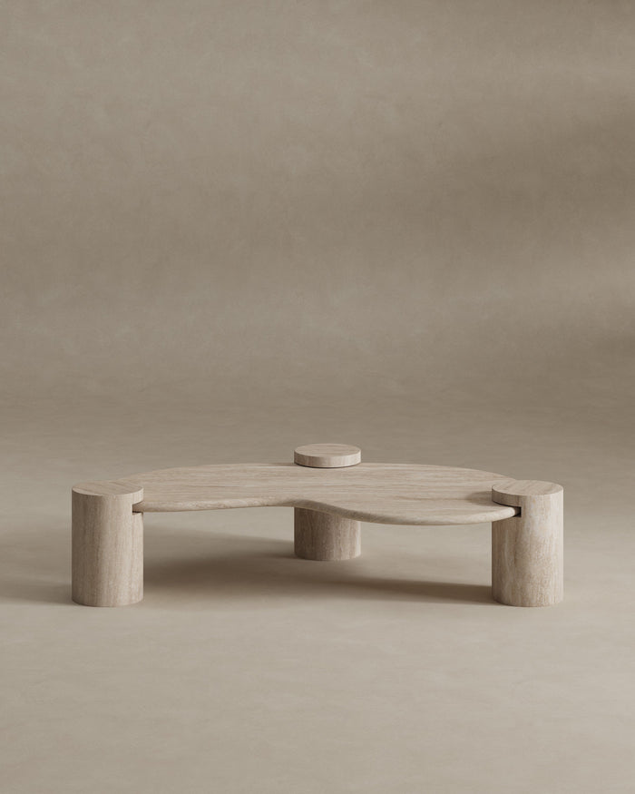 Tuscani kidney-shaped travertine coffee table on three round stone legs